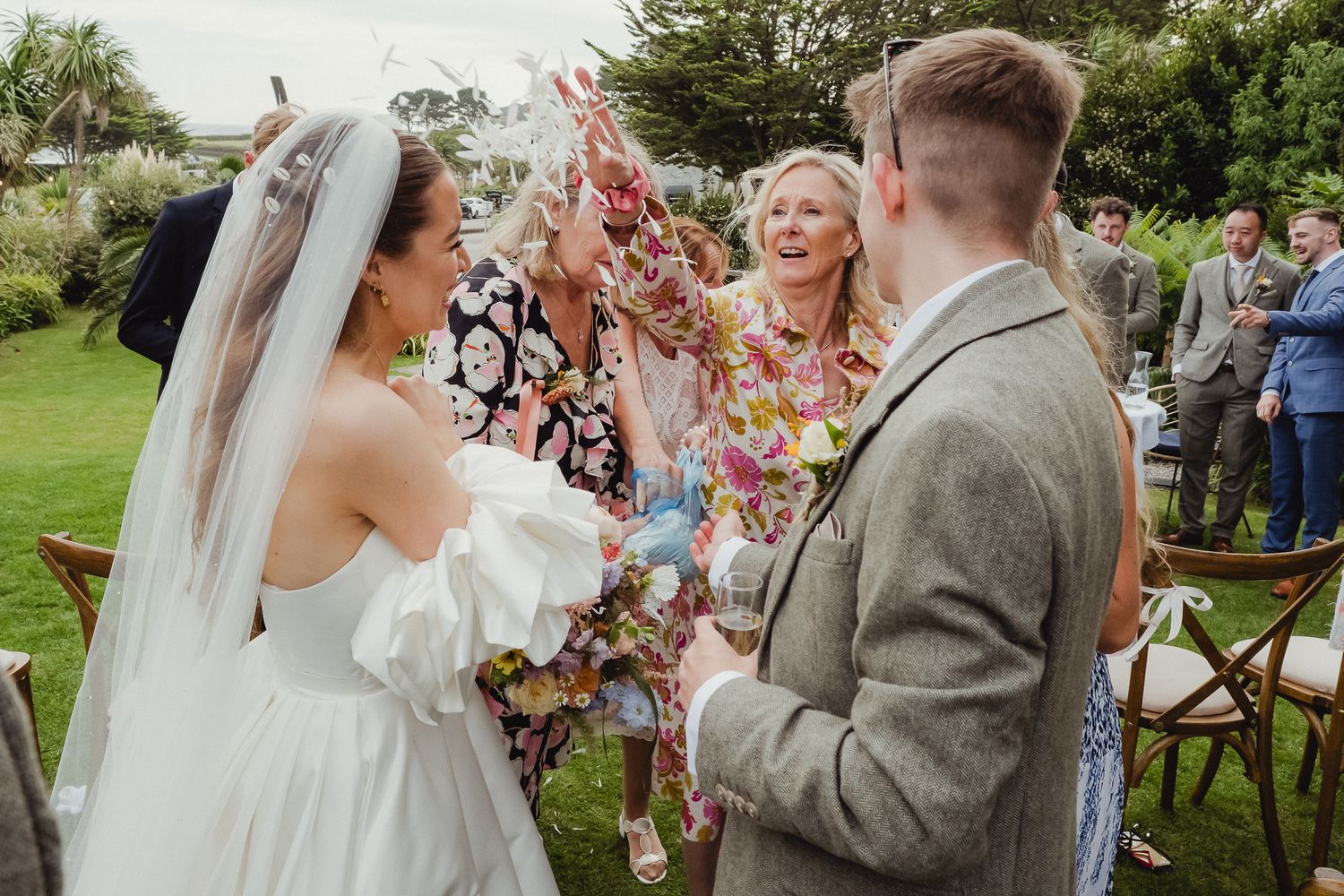 A series of candid wedding moments captured during an outdoor garden ceremony showing guests and celebrations.