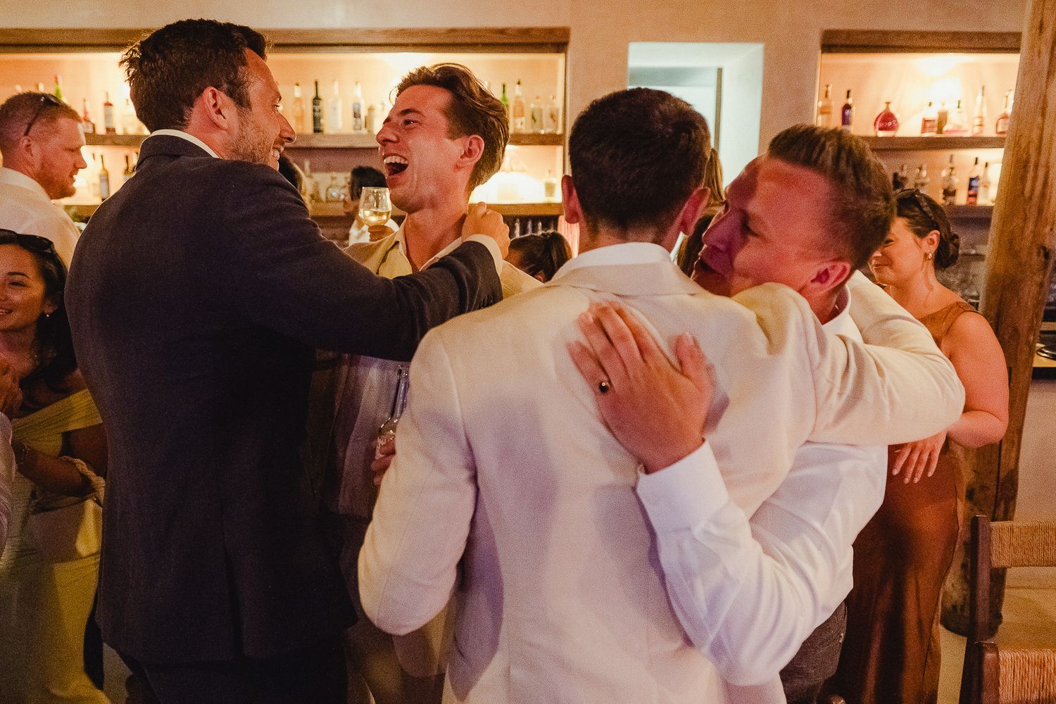 Two people share an intimate dance move at what appears to be a wedding reception or party venue.