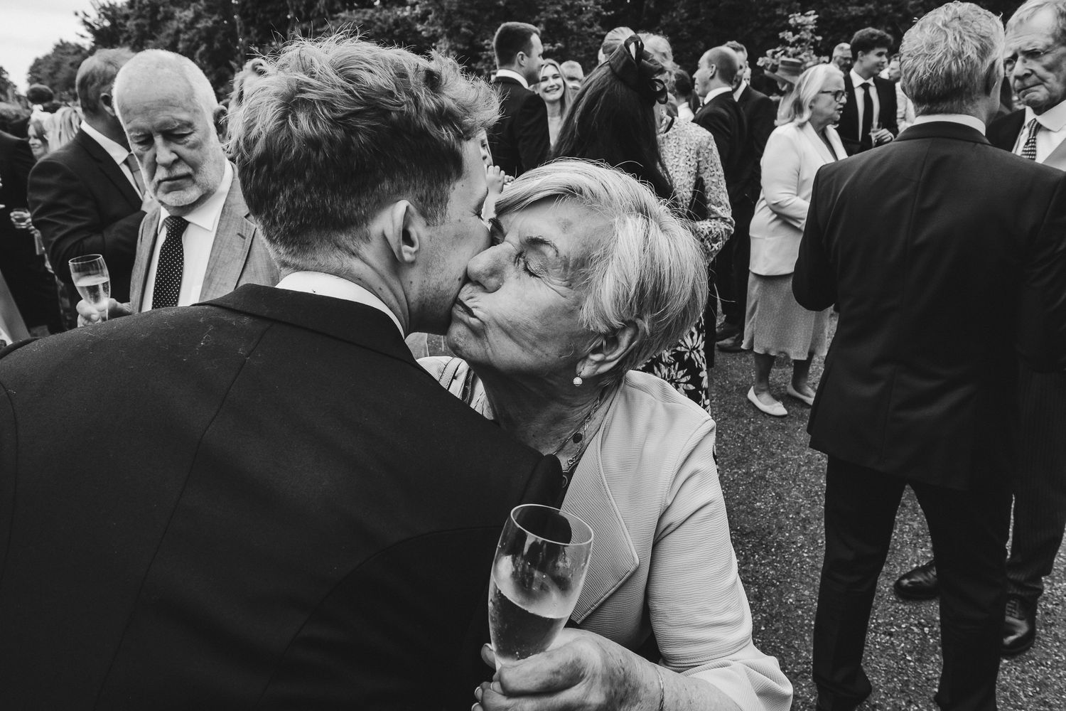 Black and white photos of a couple sharing intimate moments at their wedding reception dancing and laughing together.