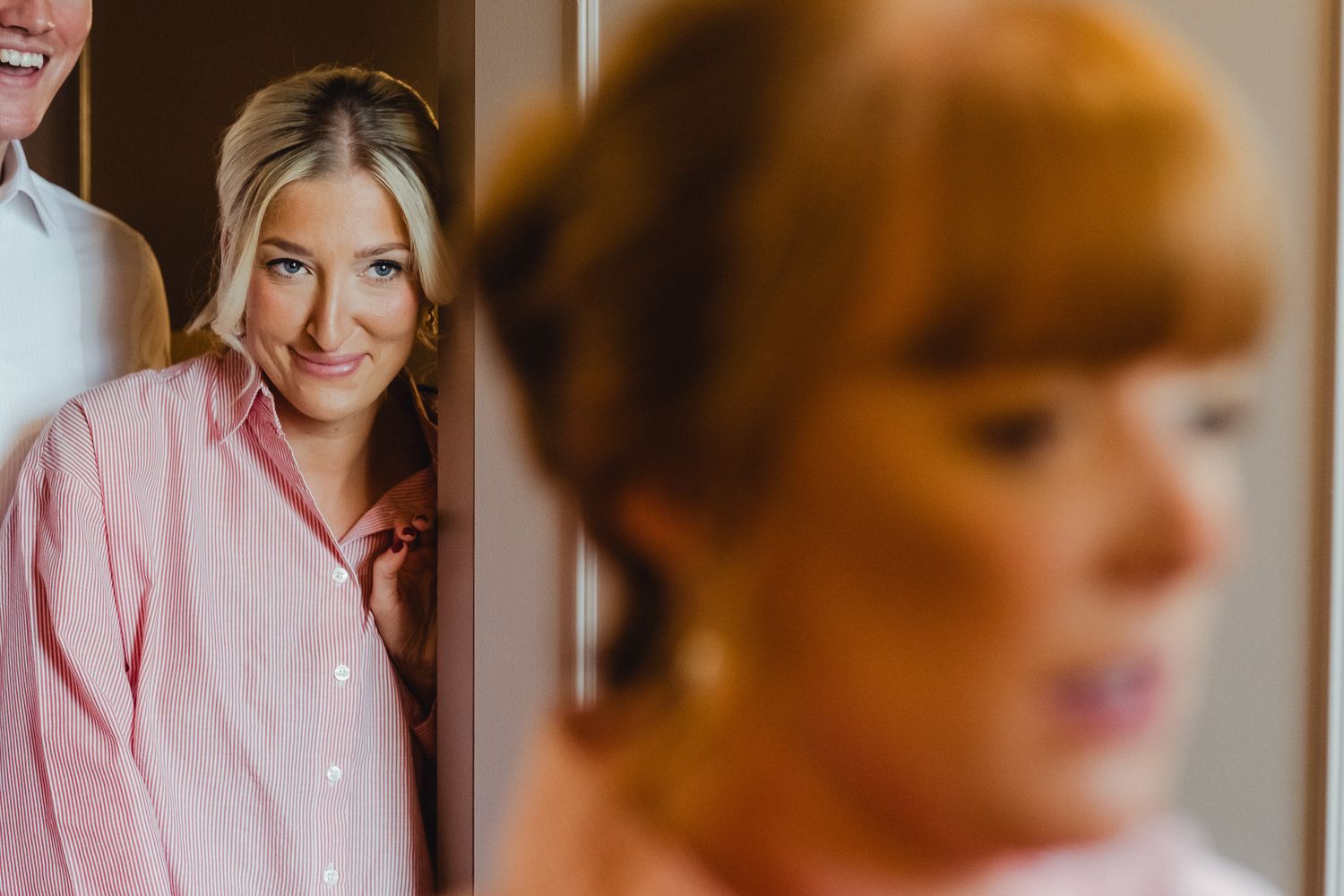 Professional portrait photos in soft pink tones showing different poses and expressions.