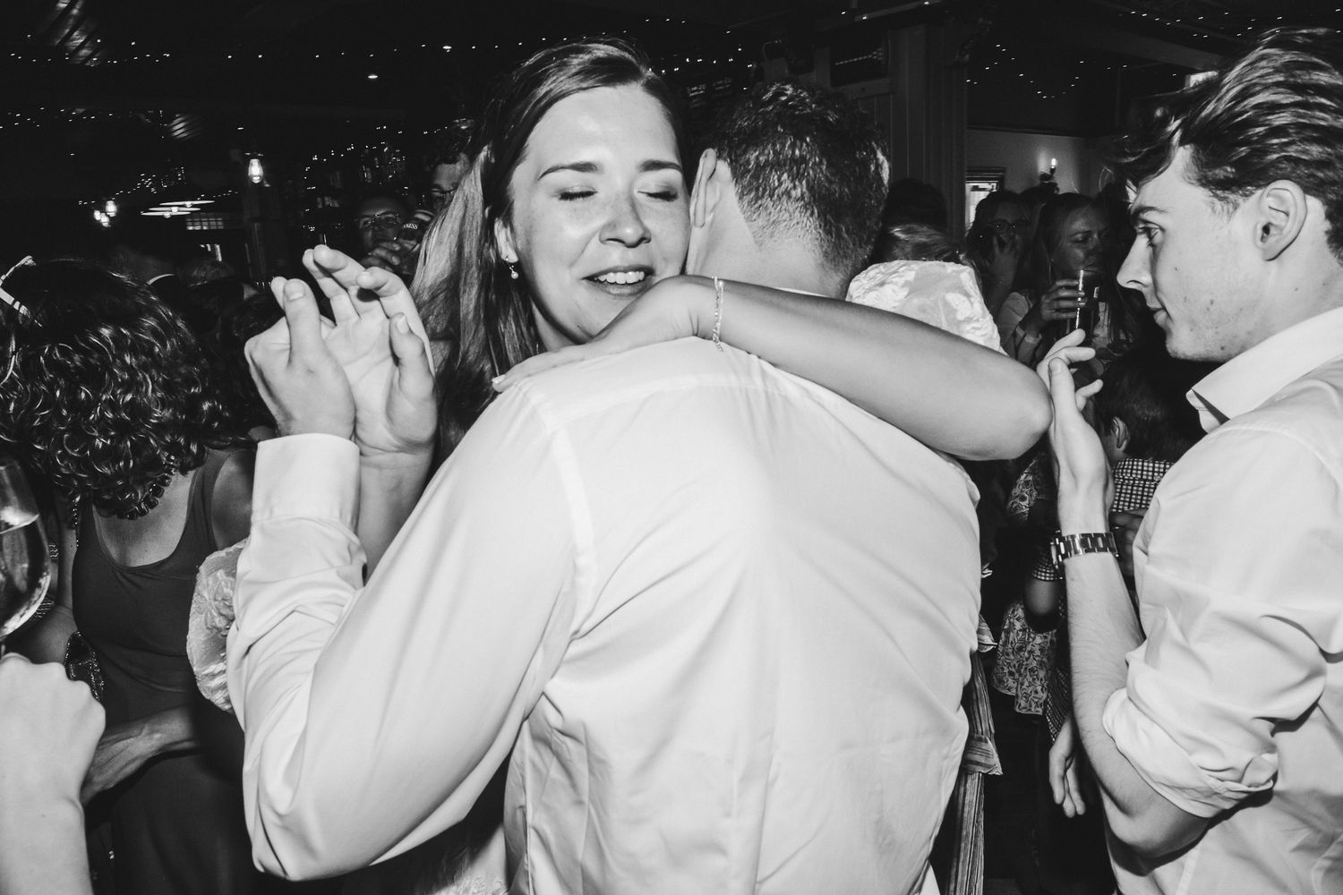 A black and white photo sequence showing couples dancing and embracing at what appears to be a celebration or party.