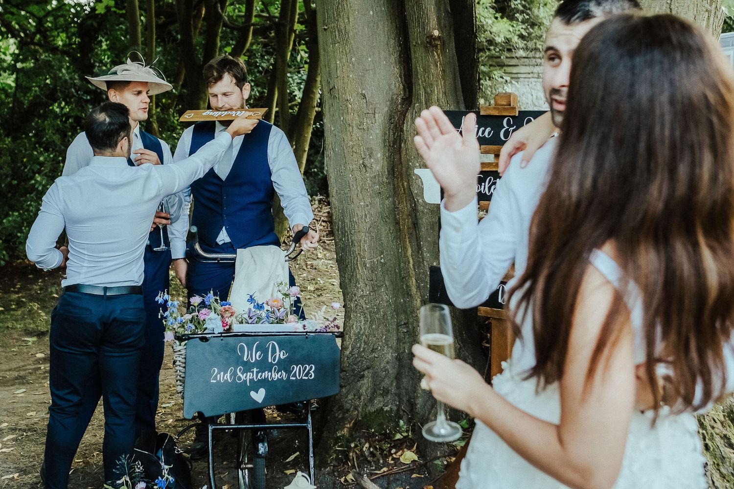 Wedding guests toast and celebrate during outdoor garden party.