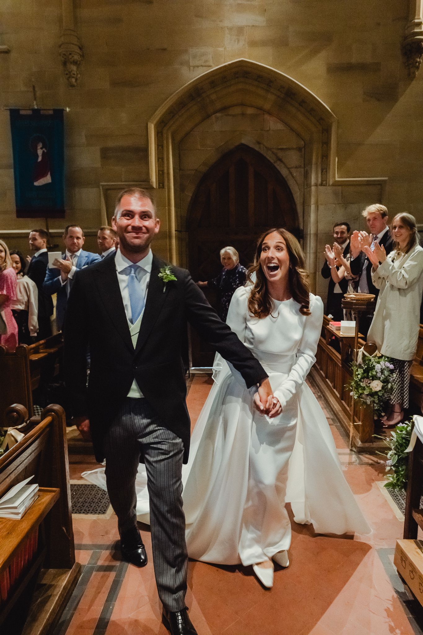 A joyful wedding celebration sequence showing the newlyweds exiting a church ceremony with guests looking on.