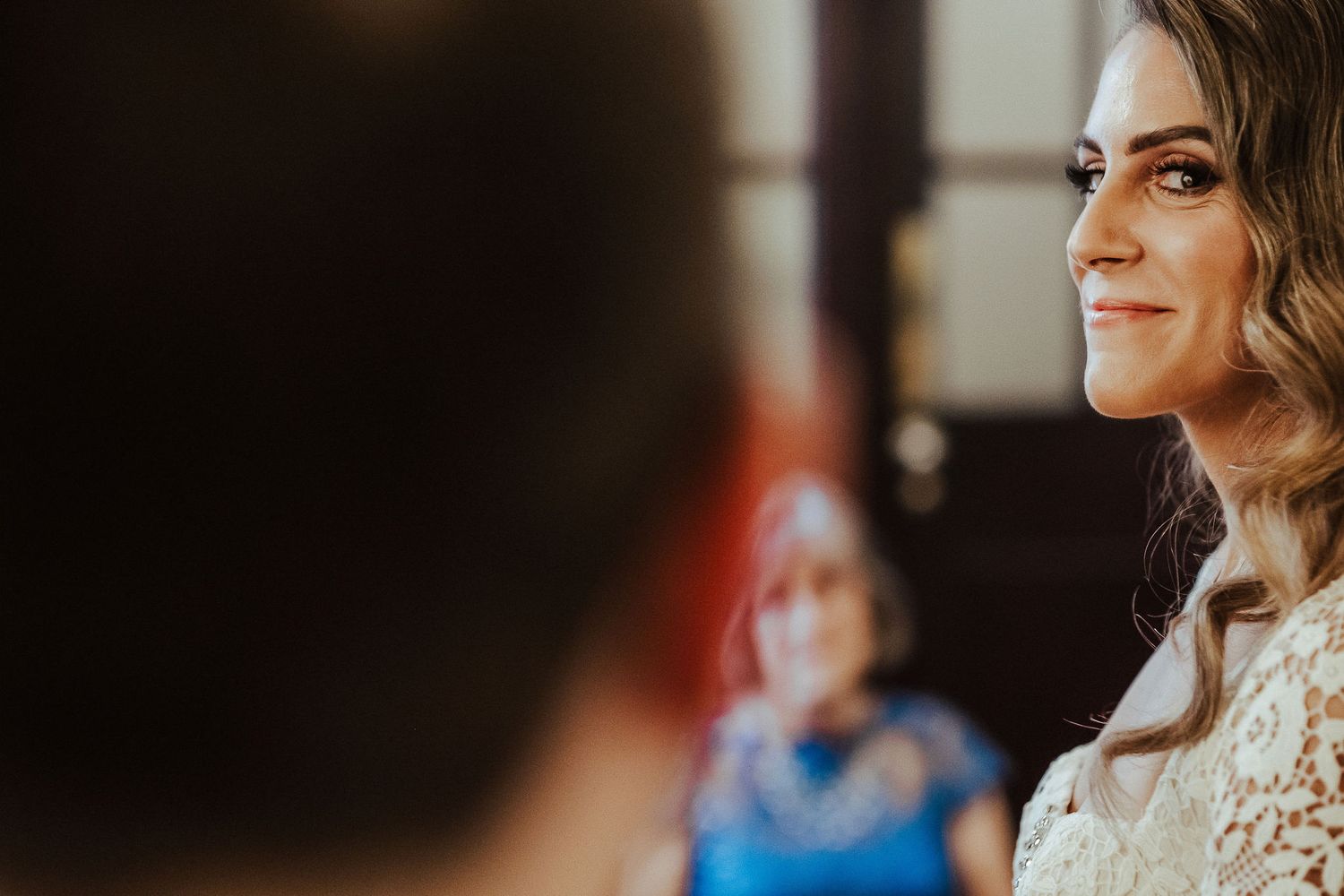 A tender moment during a wedding ceremony as a couple shares an intimate exchange in warm lighting.