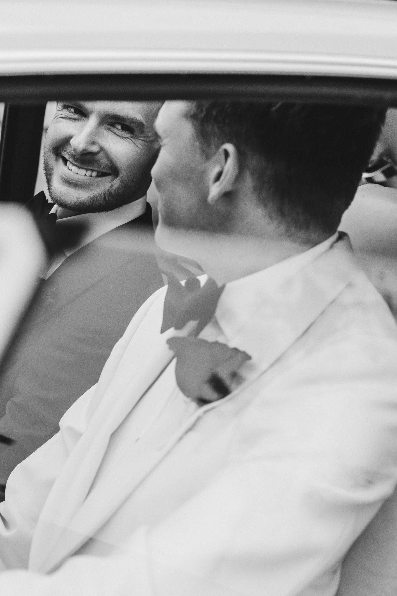 Black and white artistic wedding photo series showing intimate moments between couple in white attire.