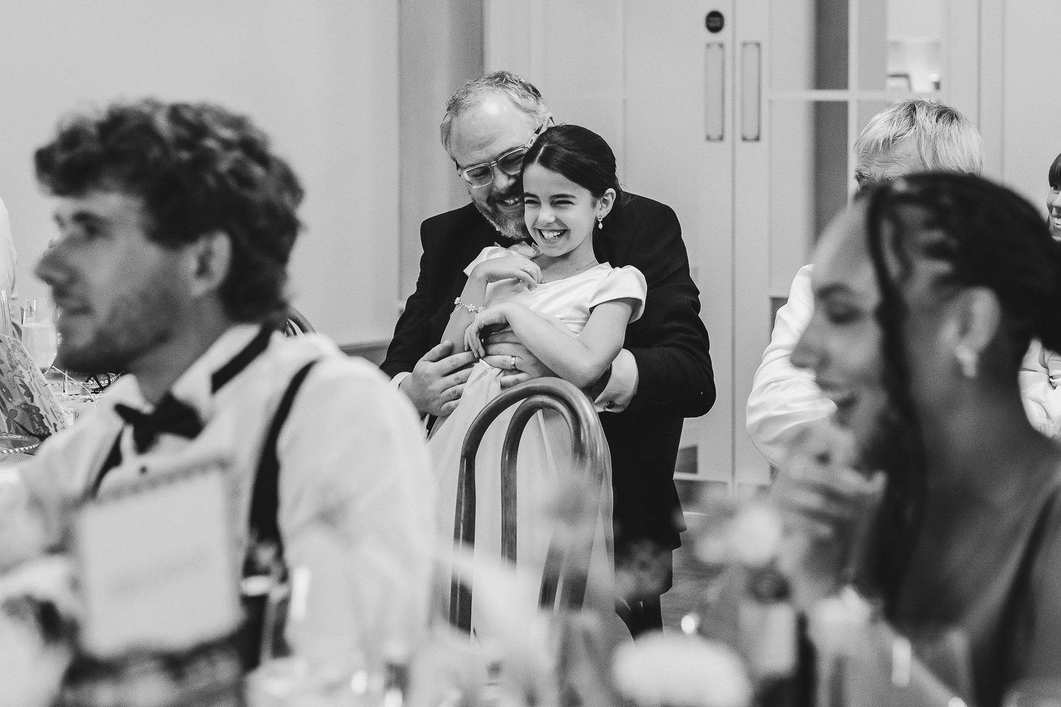 A series of candid black and white photographs showing tender moments between parents and children.