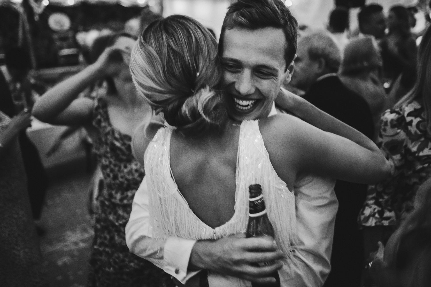 Black and white capture of tender moment during wedding reception dancing.