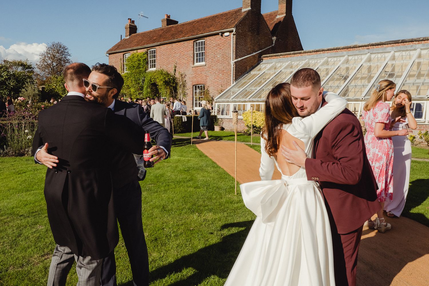 A series of candid outdoor wedding photos showing joyful moments between guests and the couple in a garden setting.