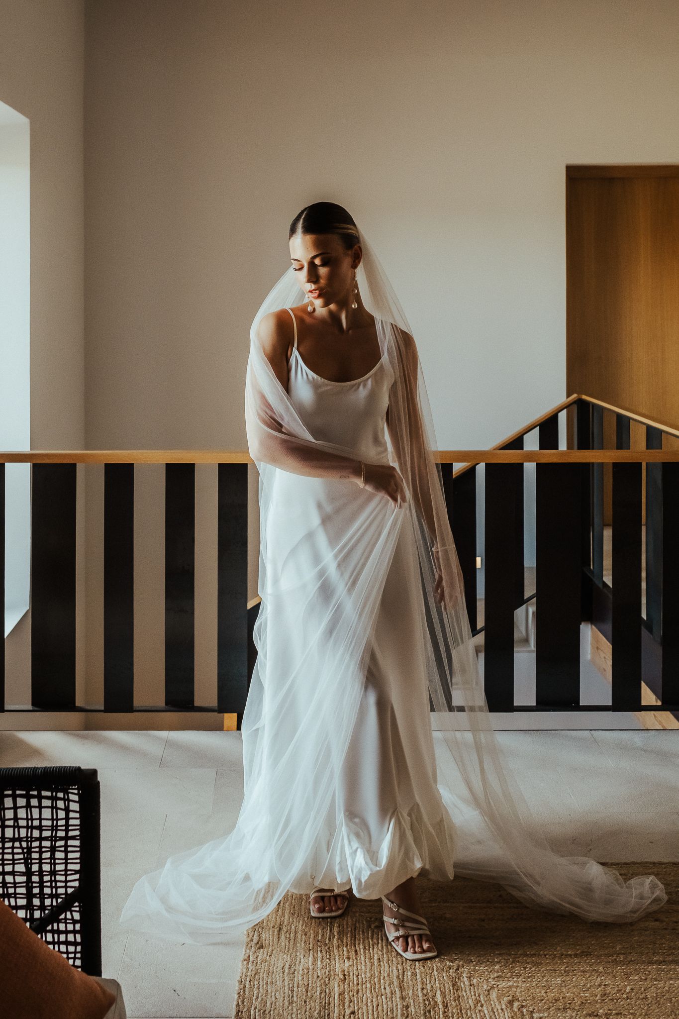 A sequence of artistic bridal portraits showing flowing white dress movement against a minimalist interior setting.