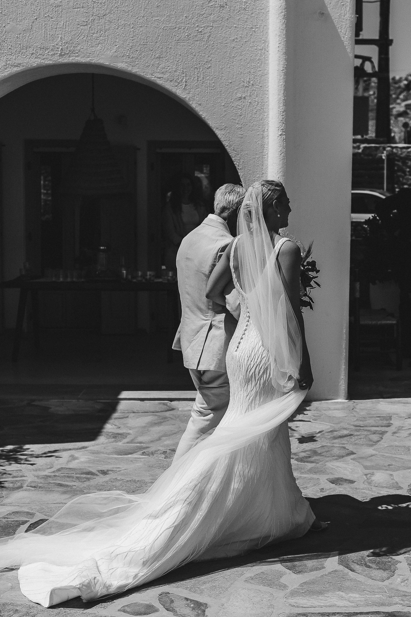 A sequence of black and white wedding photos shows a flowing white dress and veil creating elegant movement on a porch.