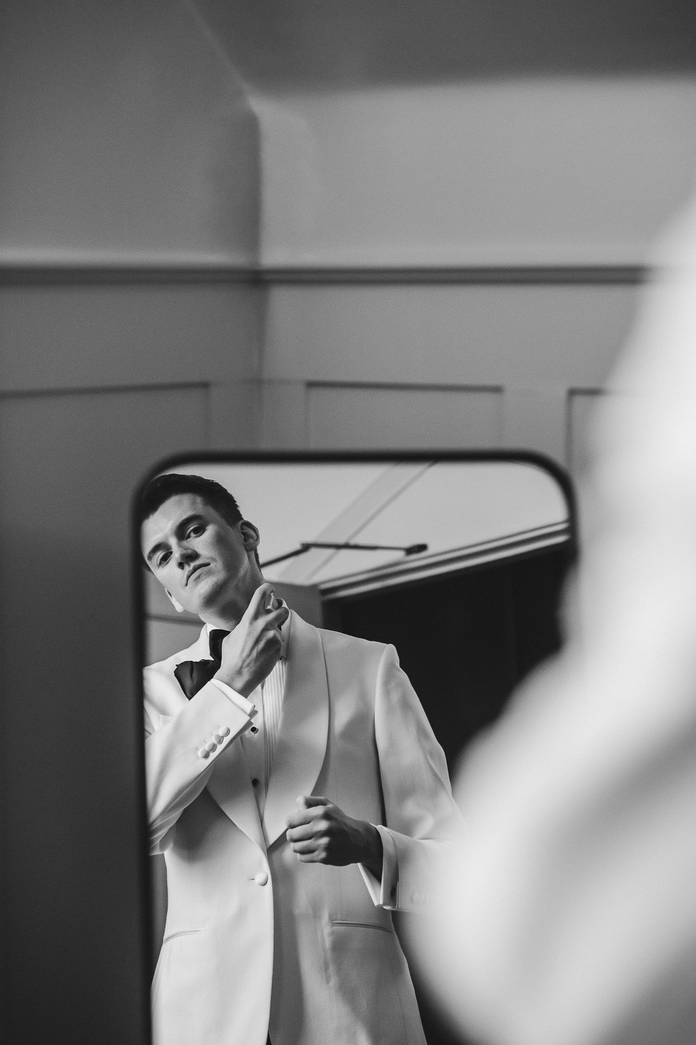 Artistic black and white fashion portrait series showing a figure in white clothing against minimalist backgrounds.