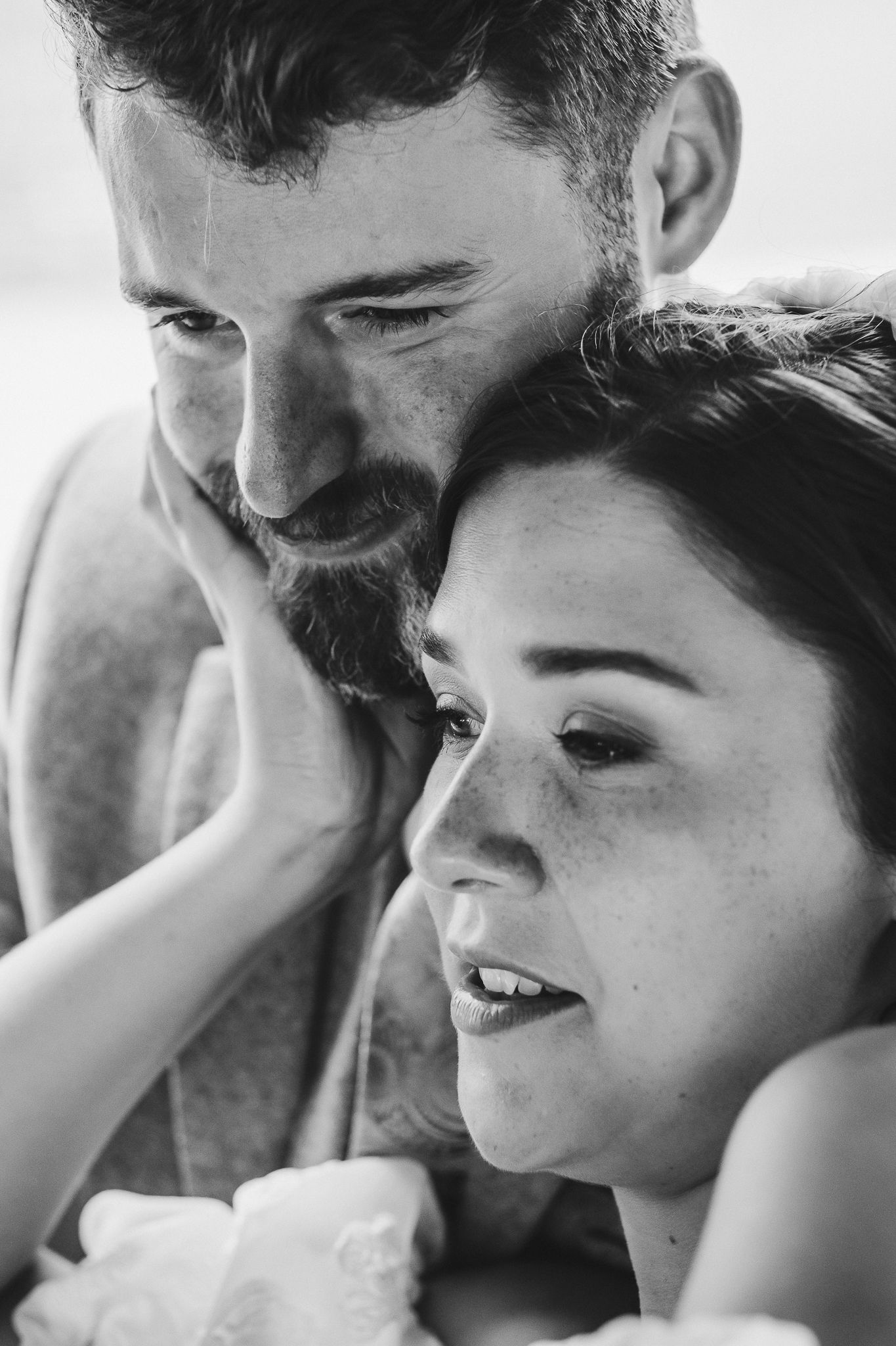 A black and white photo sequence showing tender moments of affection and laughter between a parent and child.