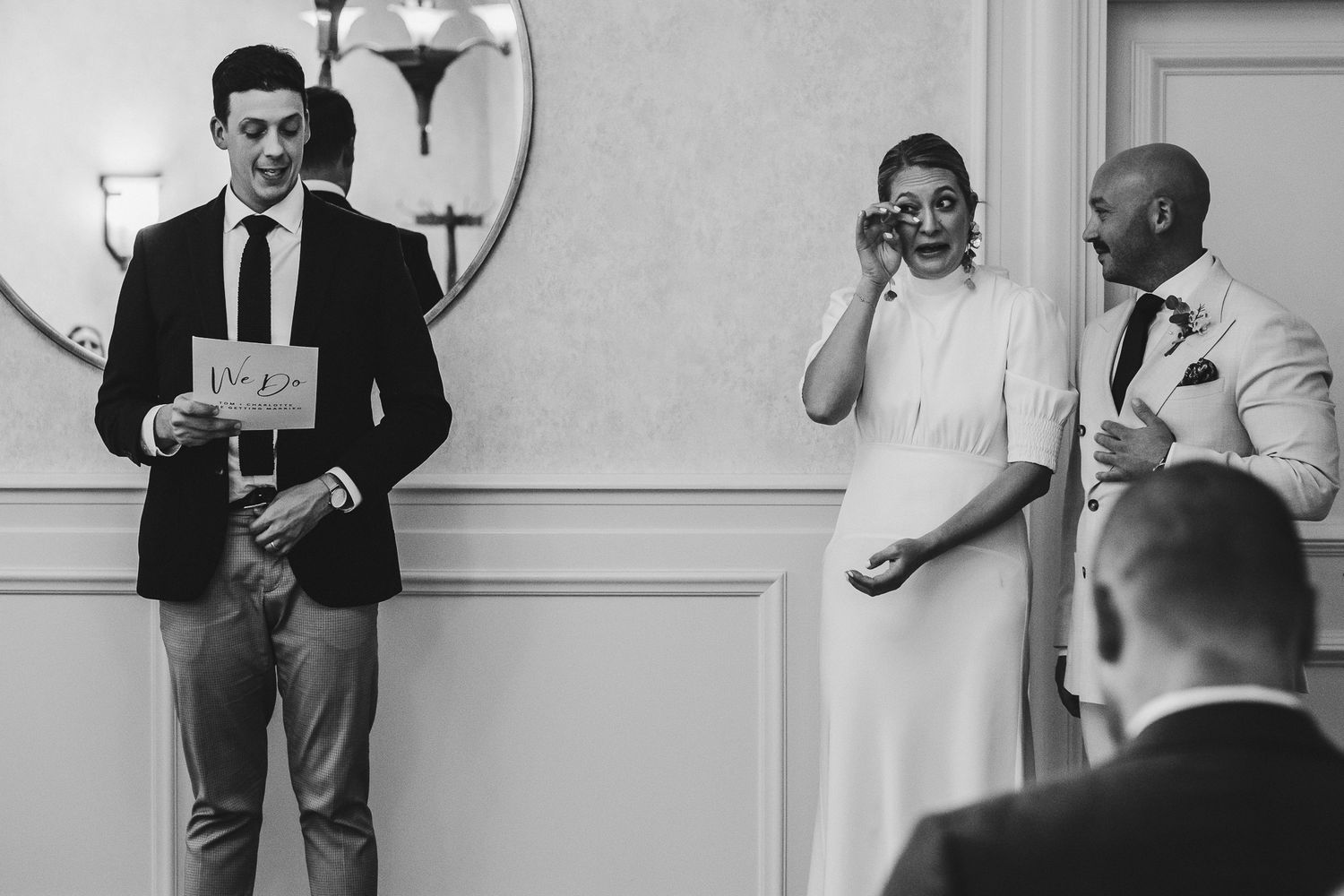 Black and white photo series showing suited individuals mingling and socializing at a formal event.