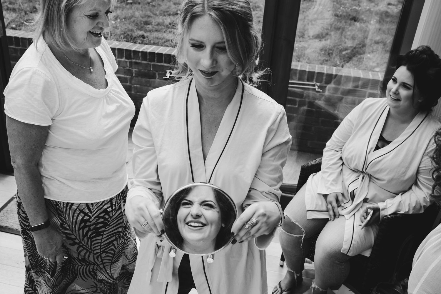 A candid black and white moment of people in robes sharing laughter.