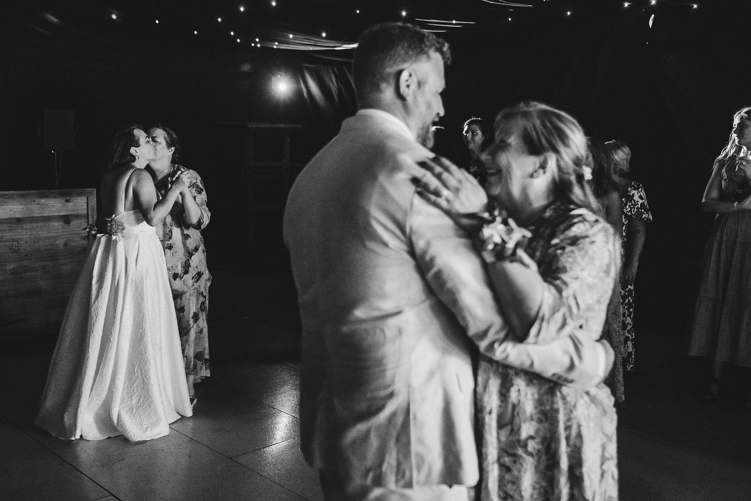 A sequence of romantic dance moments at a wedding reception shown in black and white photography.