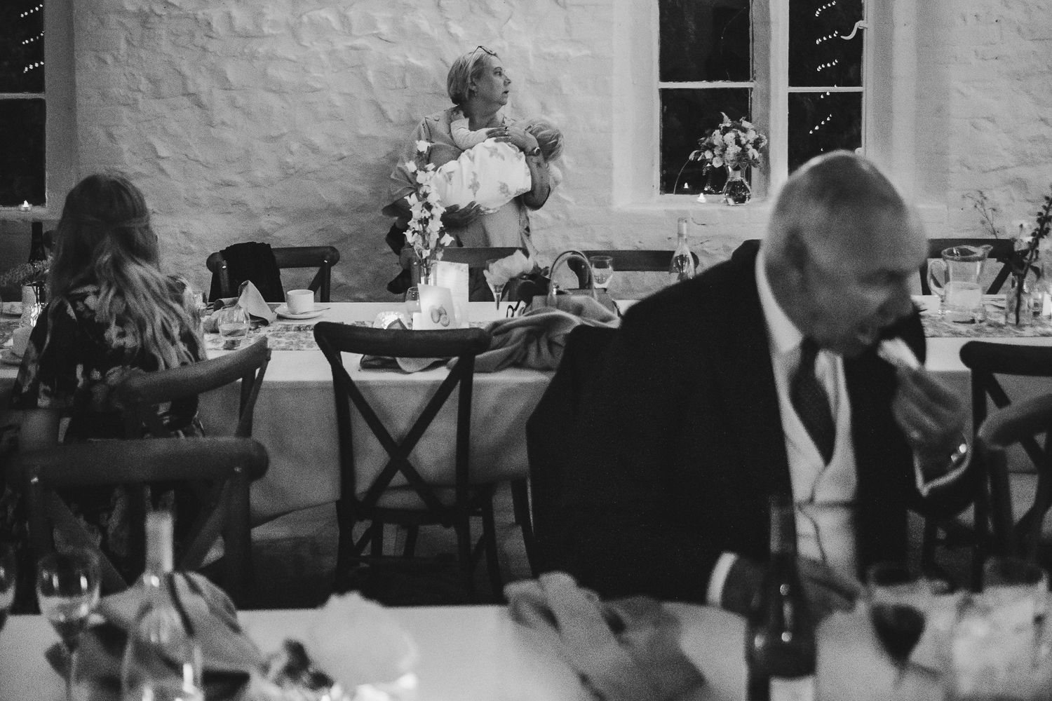 Black and white photos showing dancers enjoying a lively event at what appears to be a wedding reception or party.