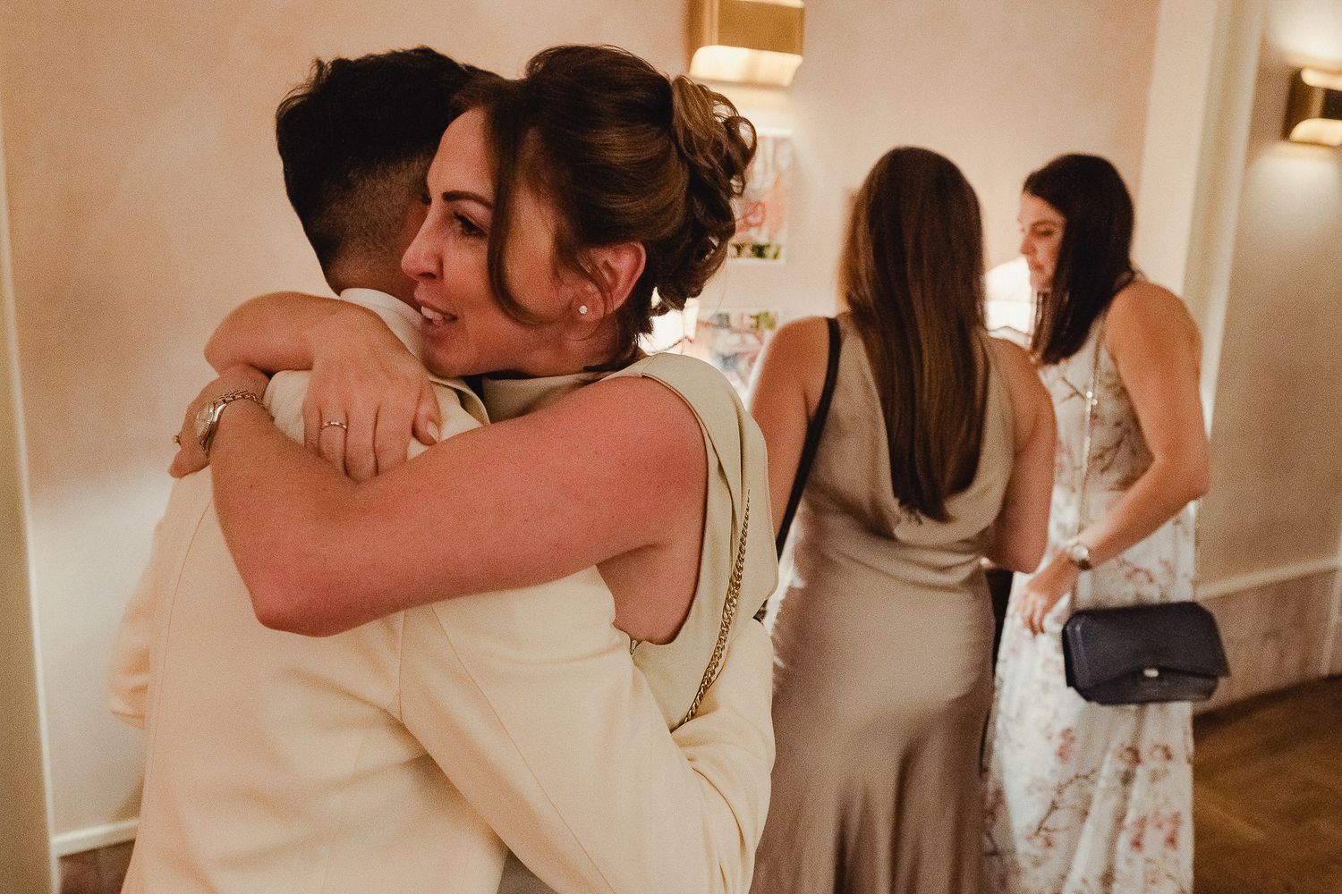 Collage of wedding reception photos showing emotional embraces and dancing moments during the celebration.