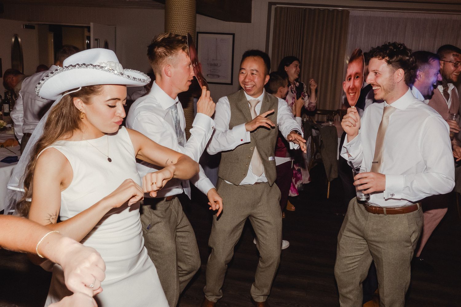 A series of wedding reception dance photos showing couples dancing and celebrating in formal attire.