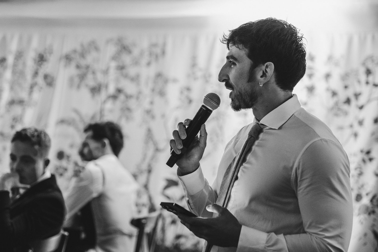 People in business attire engage in animated discussion during a networking event or meeting.