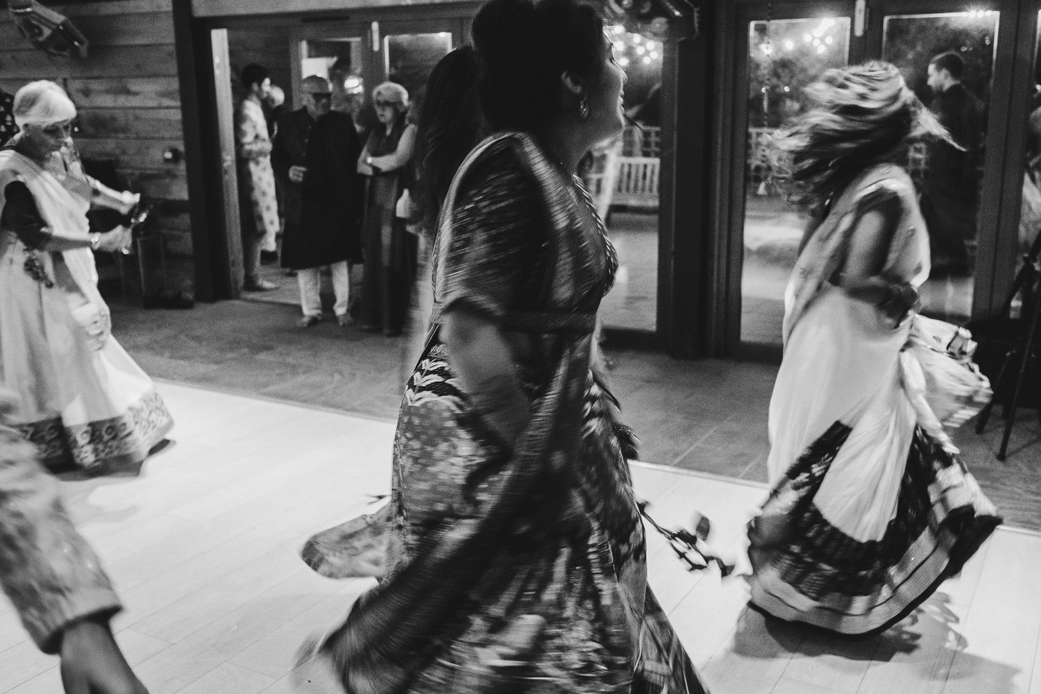 Black and white photo of people dancing in vintage dresses and clothing.