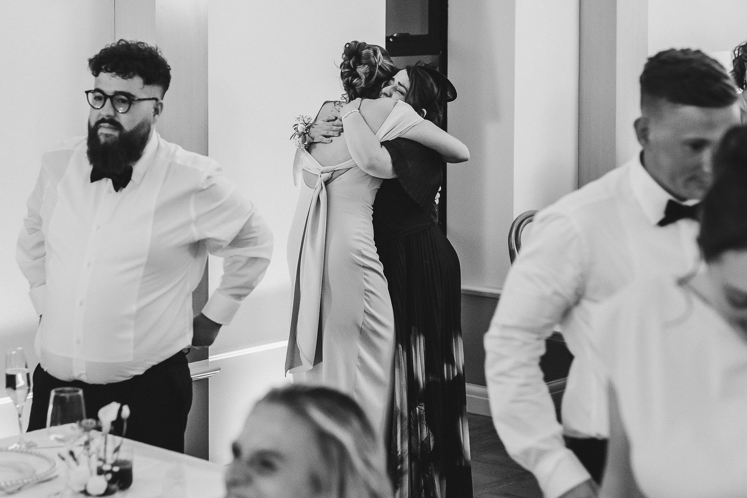 Medical professionals in white coats collaborate in a busy hospital hallway setting.