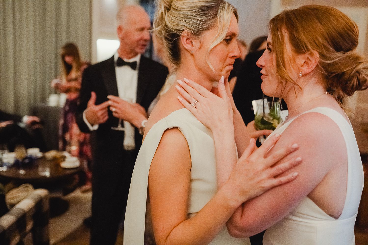Two people share an intimate dance together at a wedding reception.