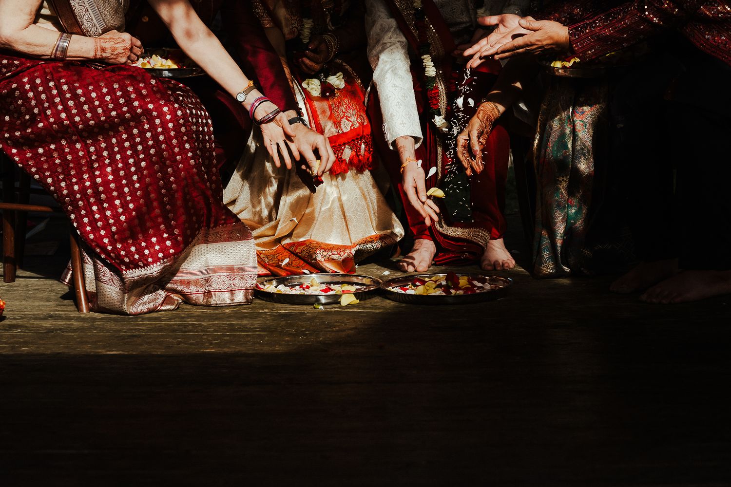 Close-up of hands and feet during a traditional wedding ritual ceremony.
