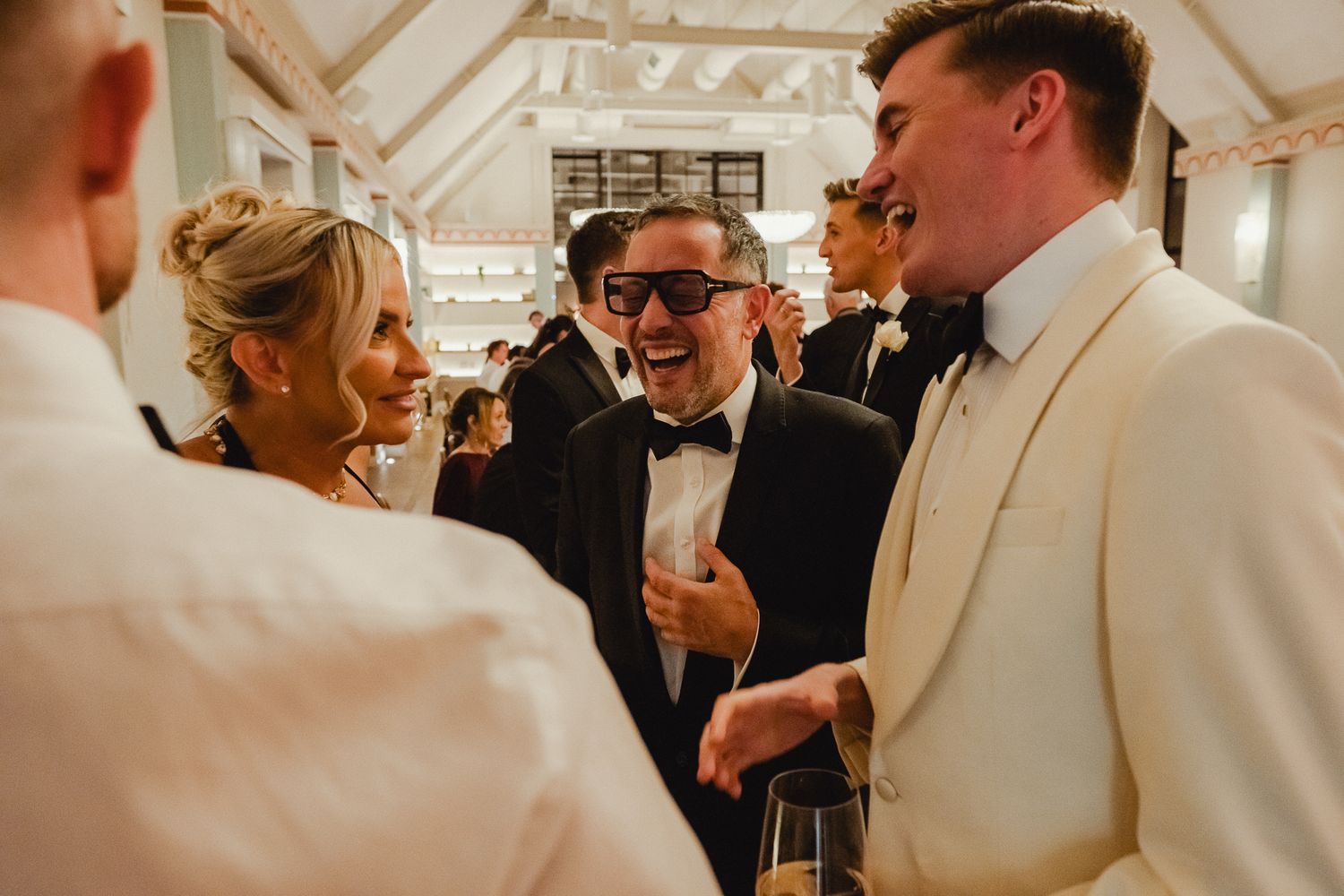 A sequence of wedding reception photos showing guests in formal attire mingling and celebrating at an indoor venue.
