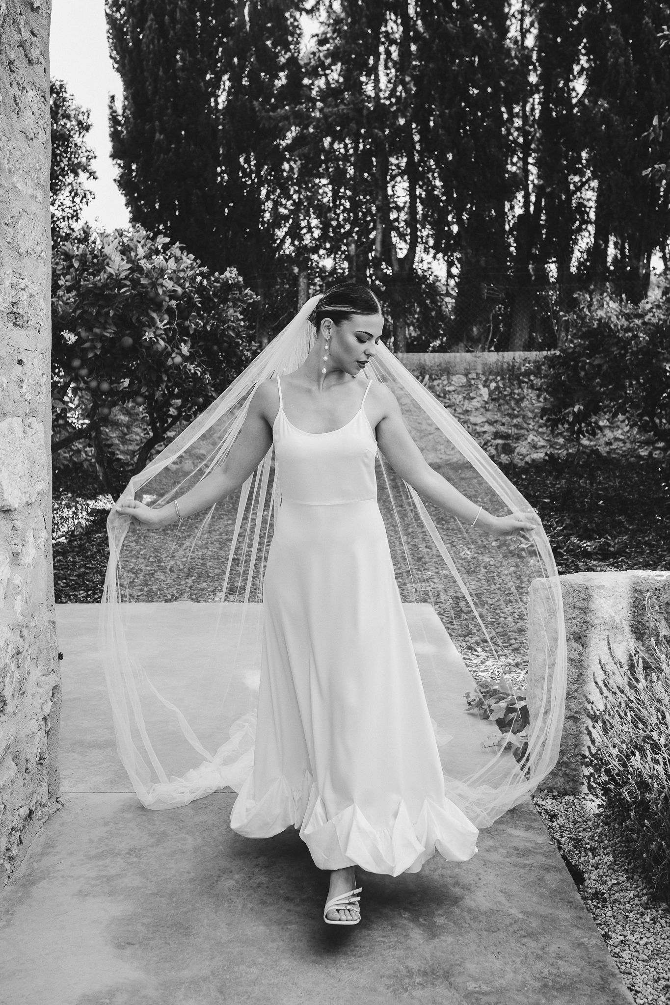 A figure in a flowing white dress twirls gracefully in a series of four artistic black and white photographs.