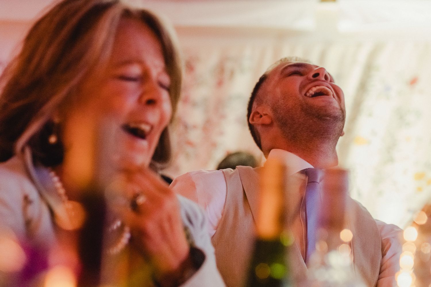 A group of people laughing and enjoying themselves at a festive celebration or party.