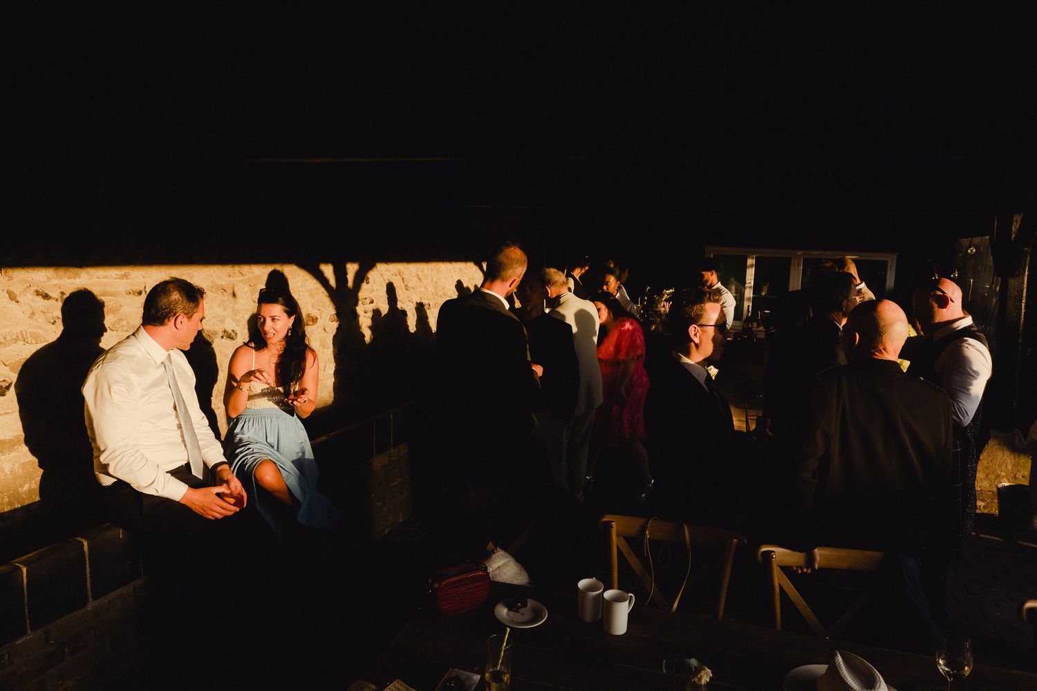 Concert audience in a dark venue with silhouettes of people watching a performance on stage.