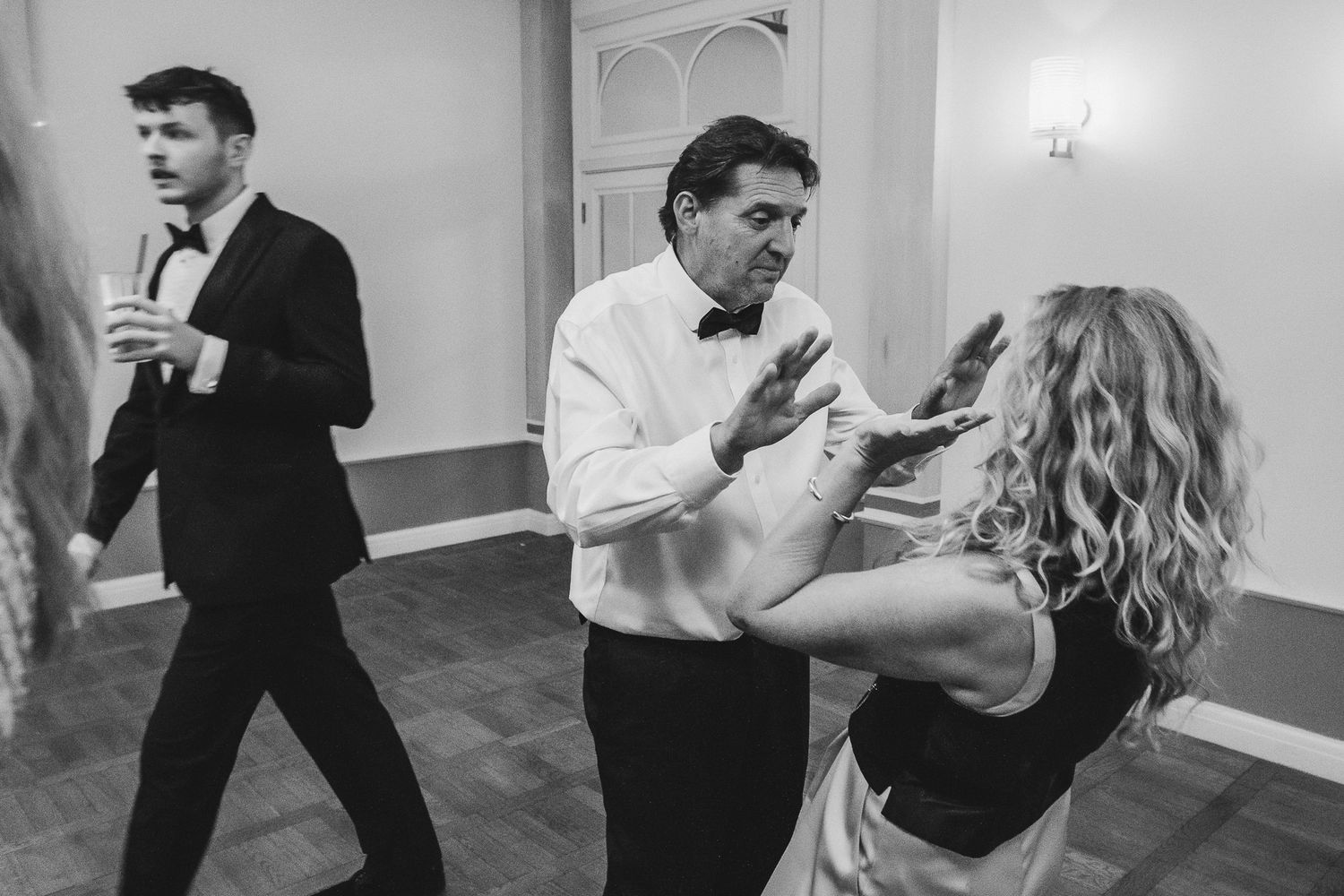 A sequence of dance moves being performed by couples in a bright indoor studio space.