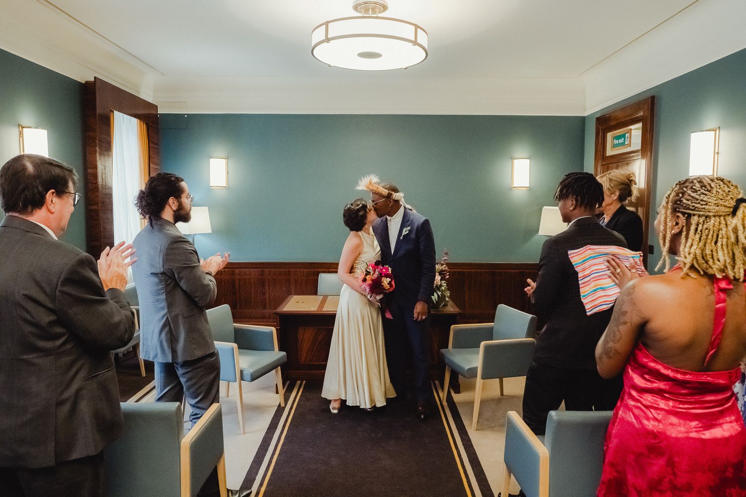 A series of candid moments from a wedding reception showing guests dancing and mingling in a warmly lit room.