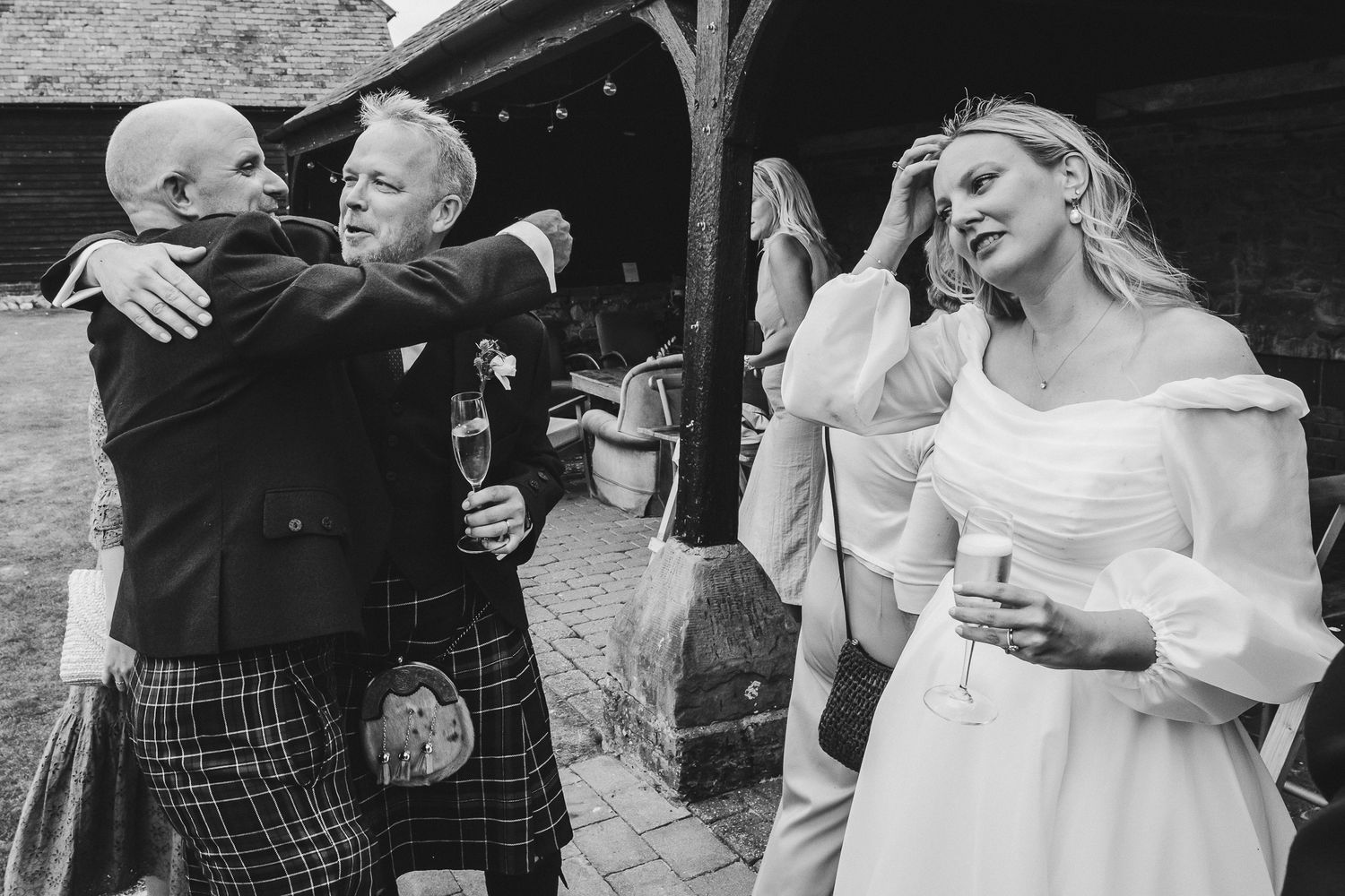Black and white photo collage showing emotional wedding moments between family members embracing at a celebration.