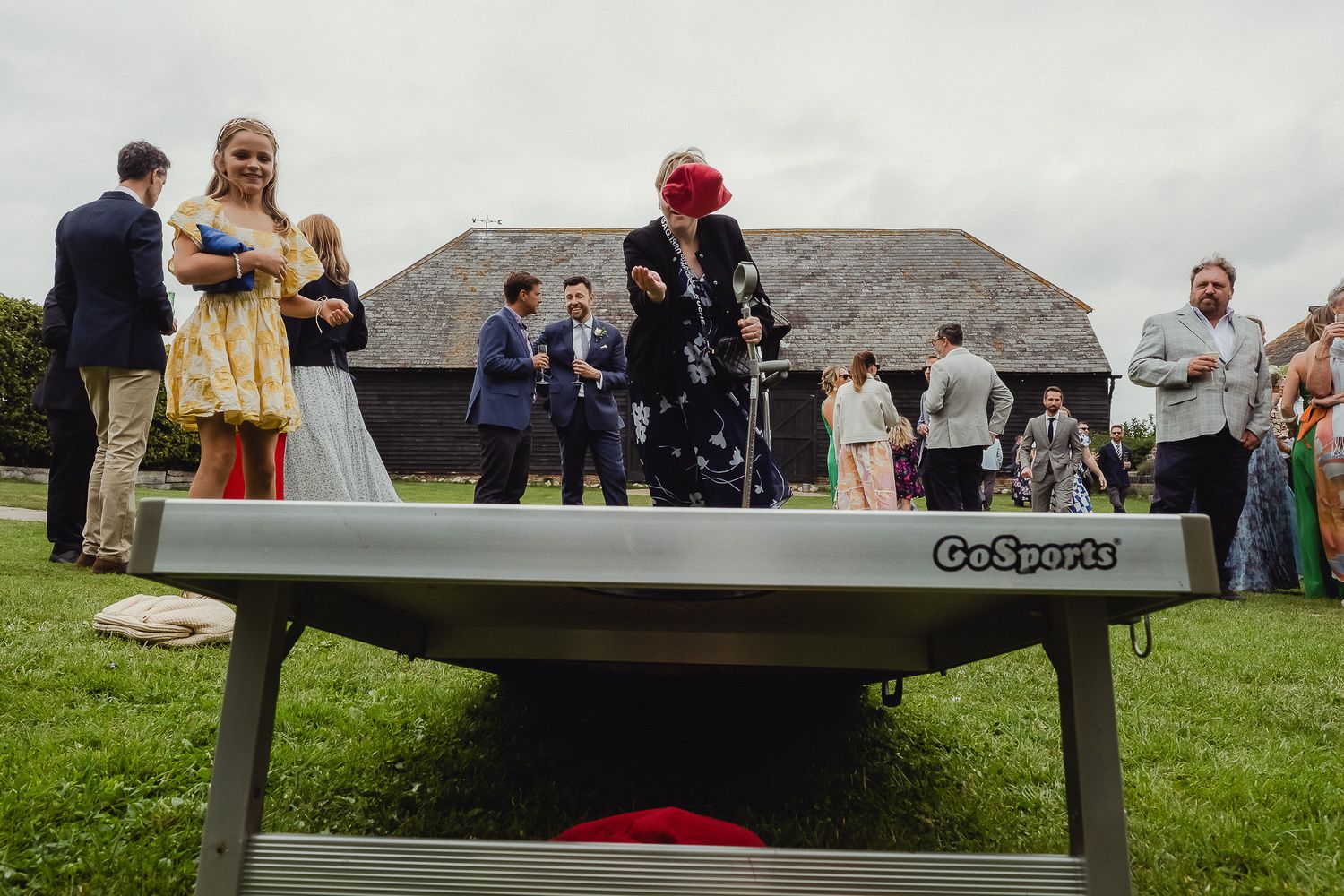 Outdoor wedding ceremony setup with wooden benches arranged on a grassy hillside overlooking a scenic landscape.