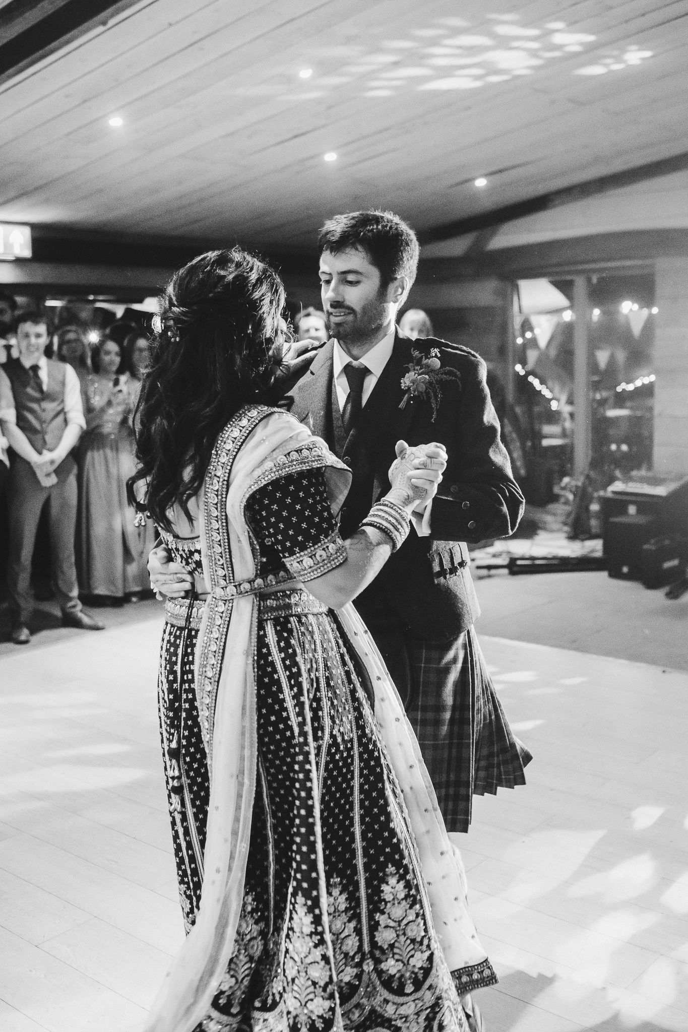 Couple sharing their first dance in a blend of Scottish and Indian wedding traditions.