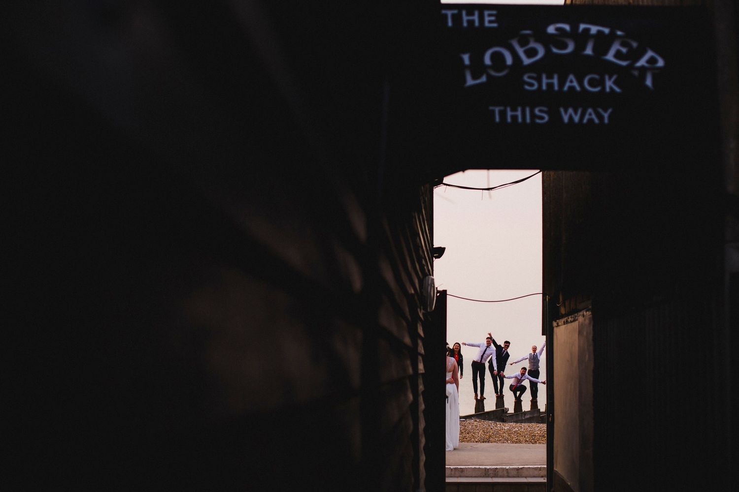 Silhouettes of people seen through doorway with Lobster Shack sign.