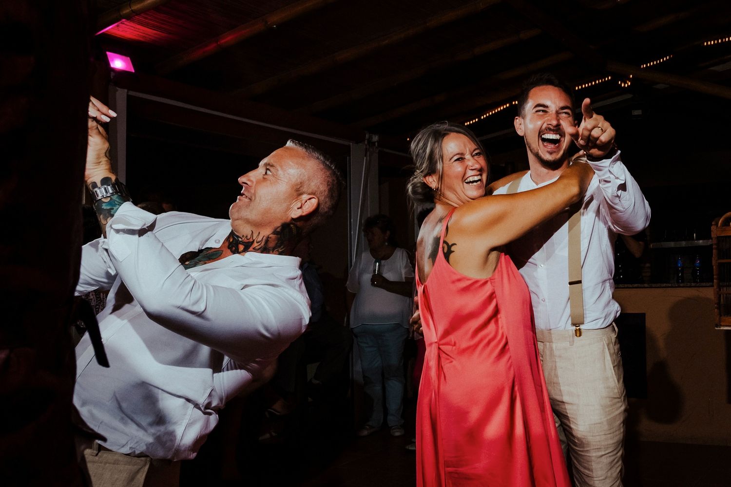 Couples dancing and celebrating joyfully at a wedding reception party.