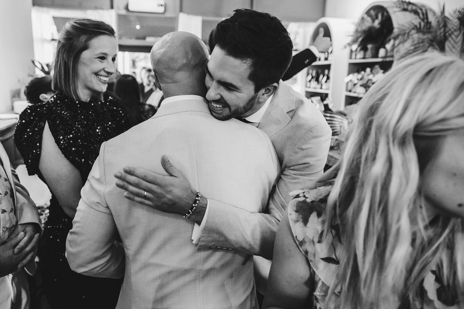 People embrace and share joyful moments at a celebration, creating a warm and festive atmosphere.
