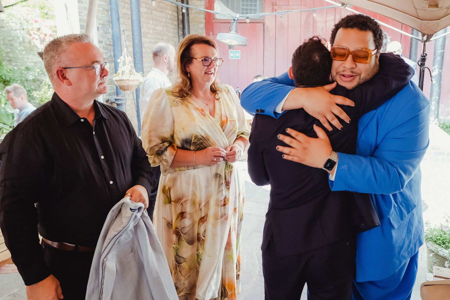 A series of candid photos showing people embracing and interacting at what appears to be a social gathering or celebration.