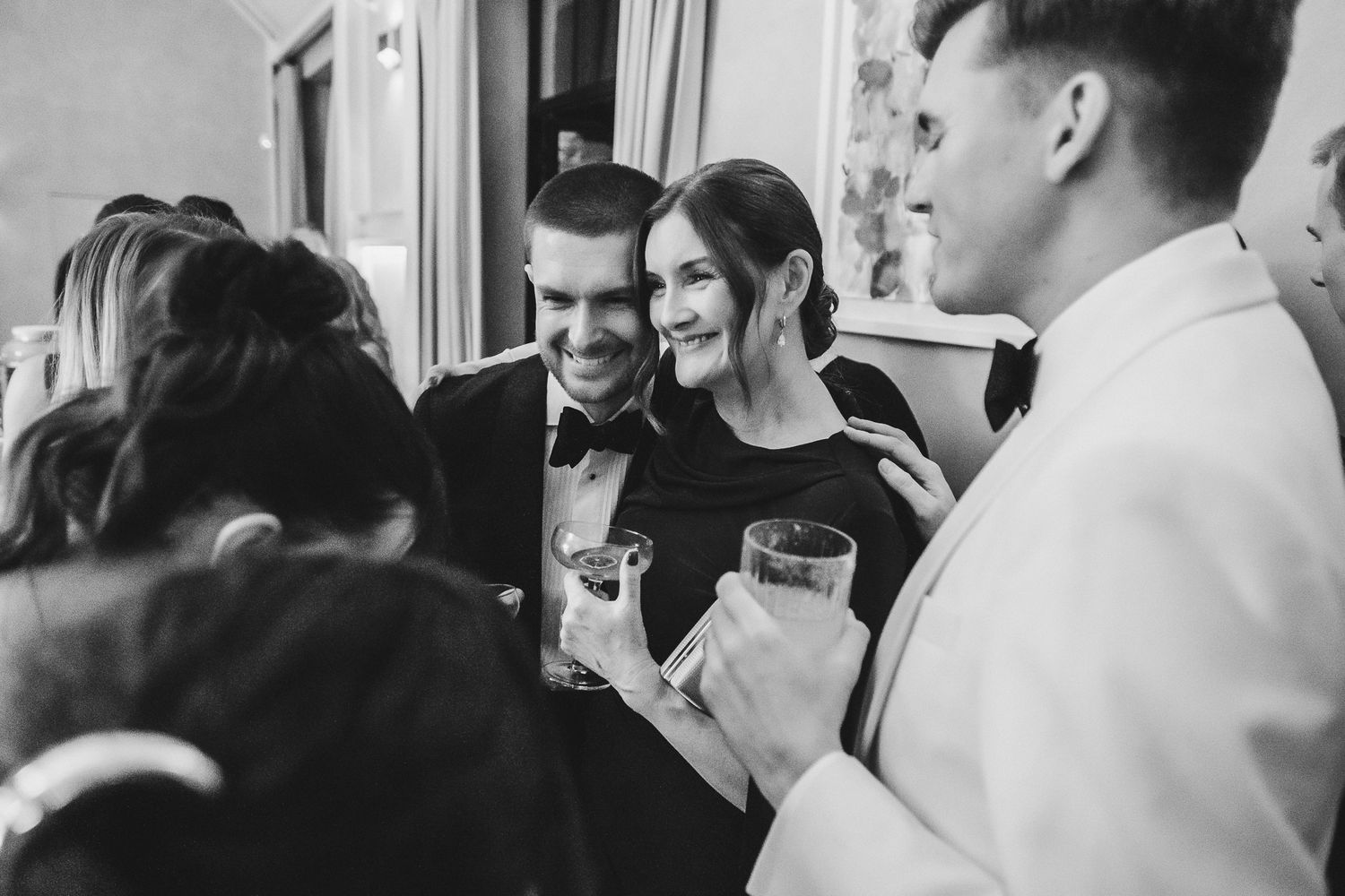 People enjoying drinks and socializing at a crowded bar or party venue.