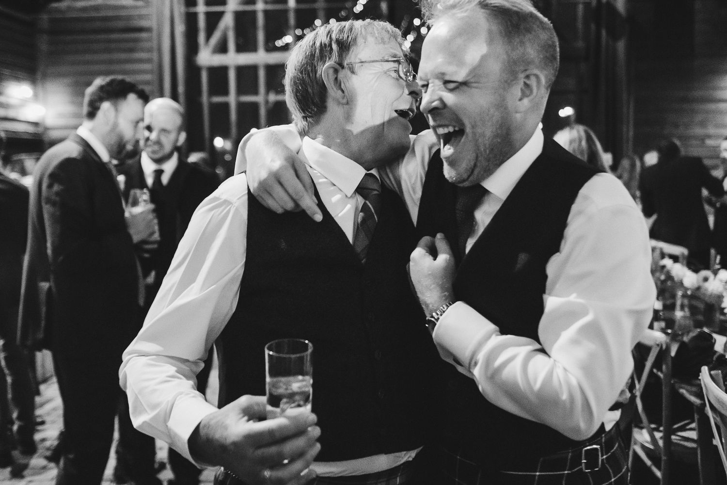 A collection of black and white wedding photos showing couples dancing and embracing at a reception celebration.