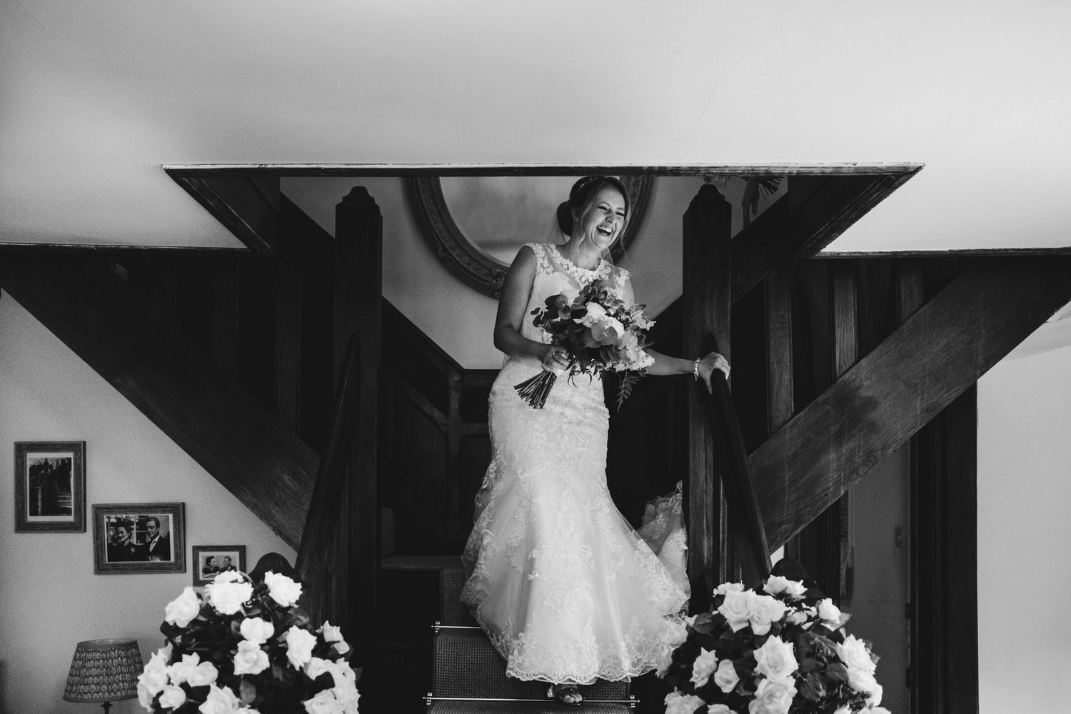 Elegant barn wedding venue with rustic wooden beams and floral decorations.