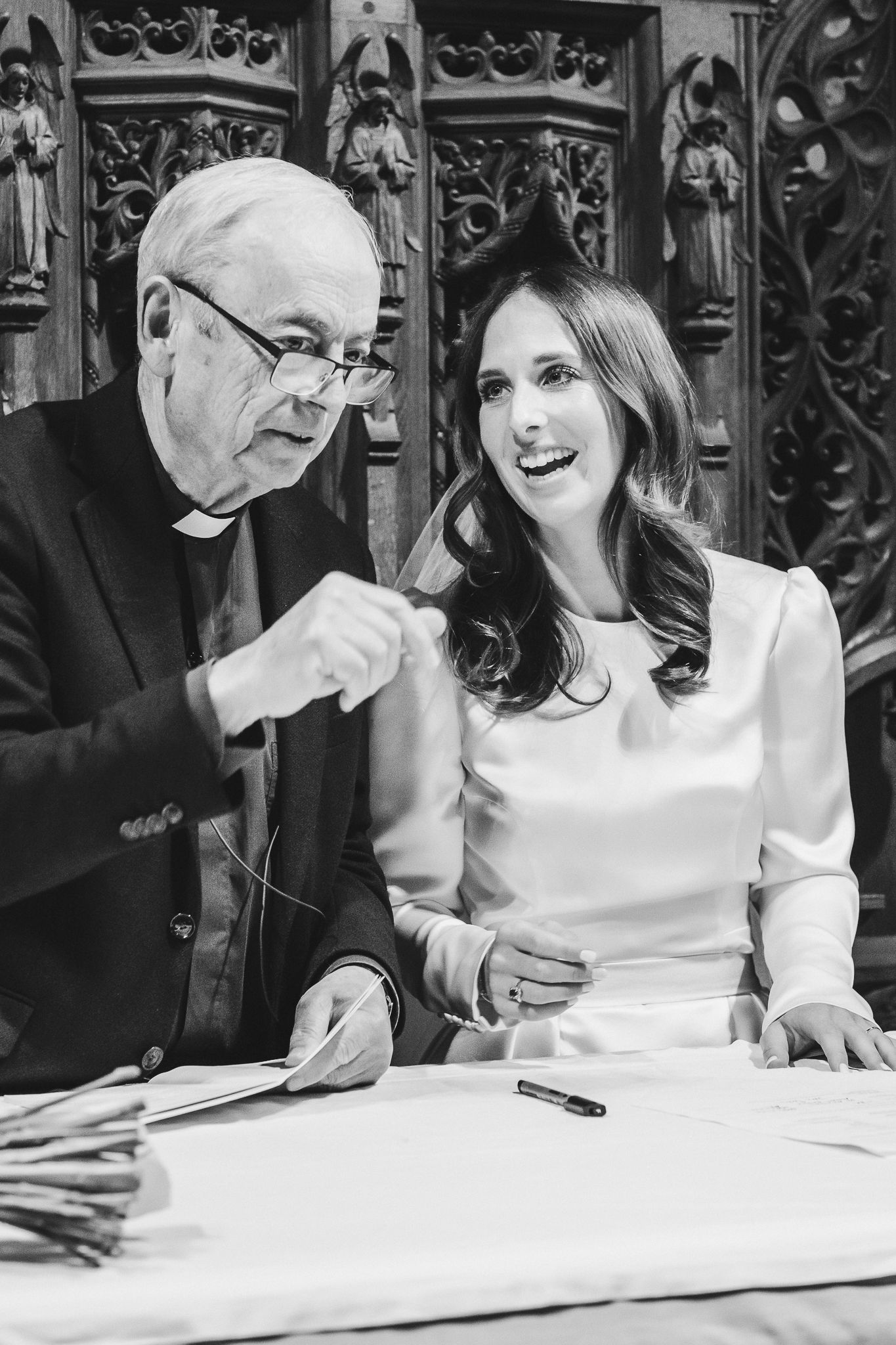 Black and white photo sequence showing joyful expressions and laughter during a document signing moment.