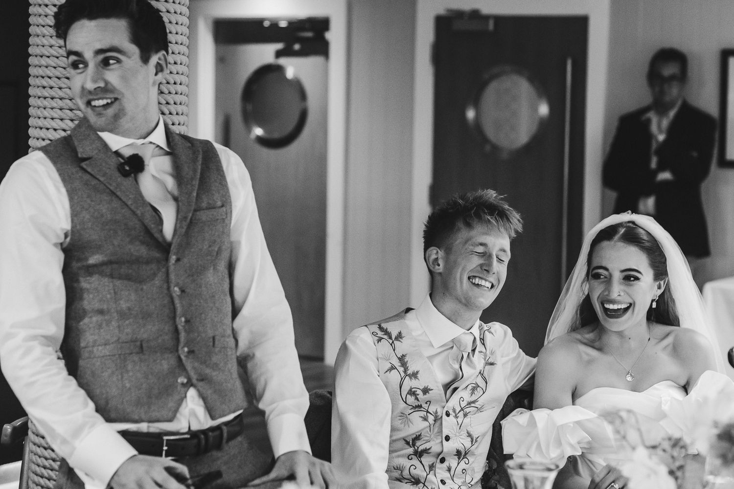 Black and white wedding photos showing joyful moments between couples and guests during a celebration.