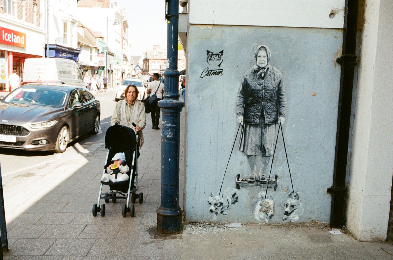 A series of four black and white photographs showing urban street scenes with strollers and pedestrians.