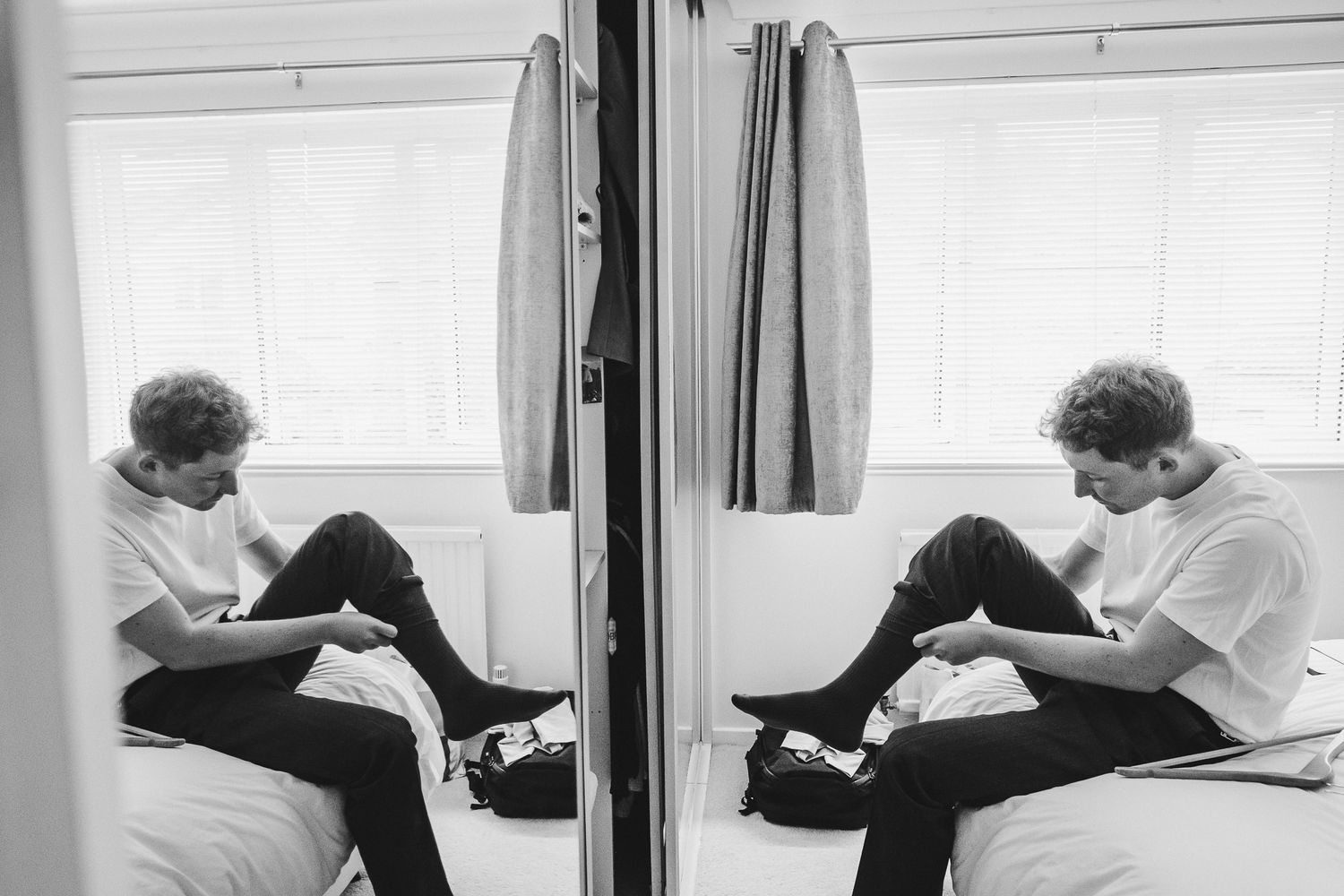 A series of black and white photographs showing someone lying in a bed turned away from the camera in different positions.