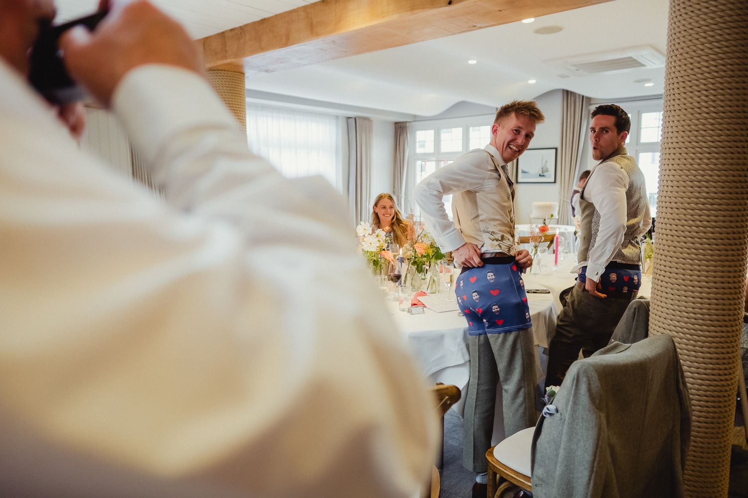 People gather around a table for an engaging group activity in a bright indoor space.