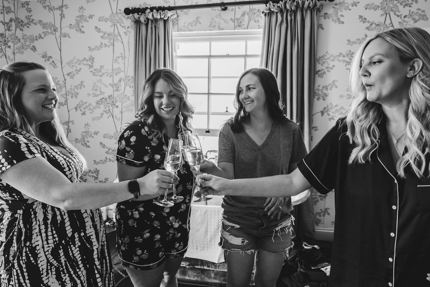 A series of black and white candid photos showing people laughing and interacting at a social gathering.