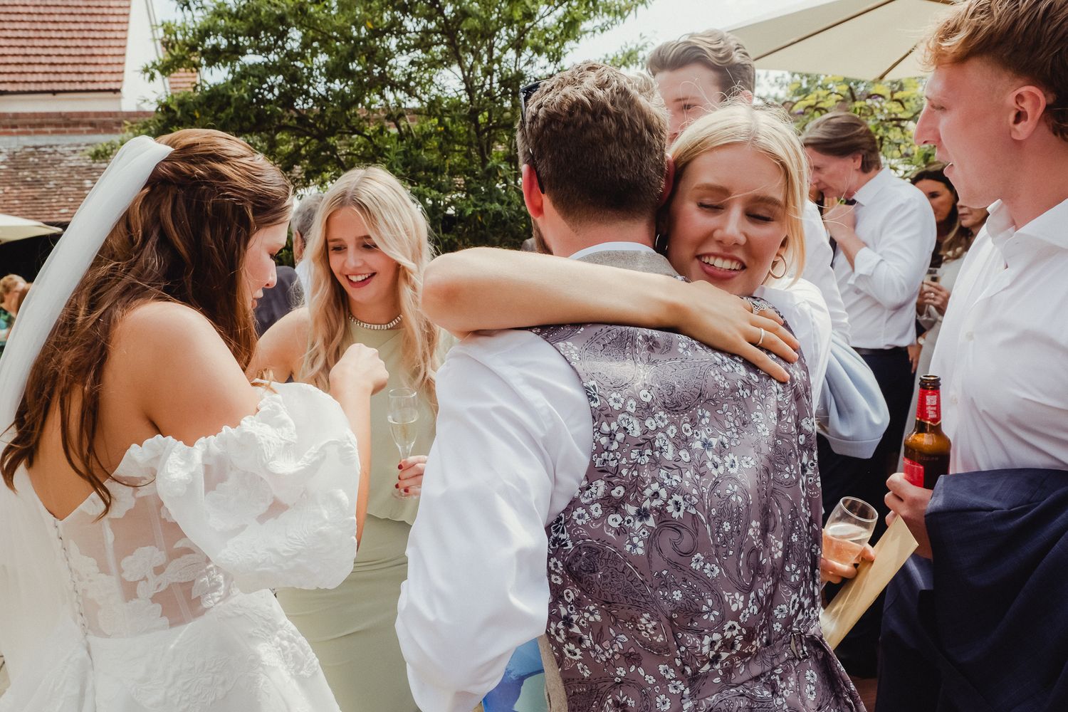 A series of candid dance floor moments showing people embracing and dancing at a wedding reception.